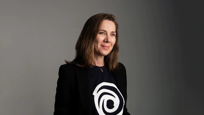 Anika Grant wearing a black T-shirt with a white Ubisoft logo smiling at the camera