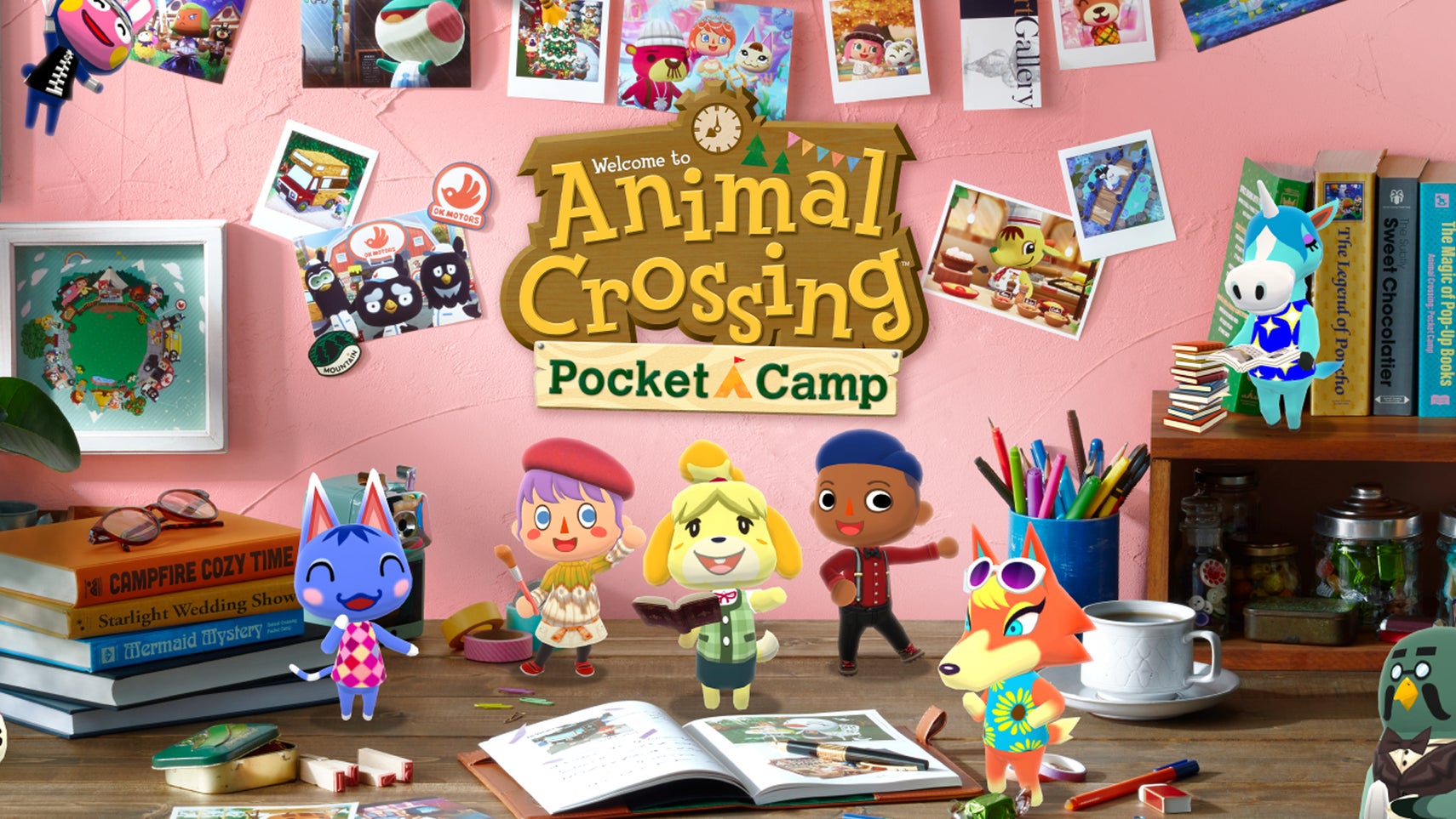 A desk filled with various characters from Animal Crossing, as well as various bits of clutter like books, photos, pencils, and trinkets, with the logo for Animal Crossing: Pocket Camp superimposed on top of it all. - 1