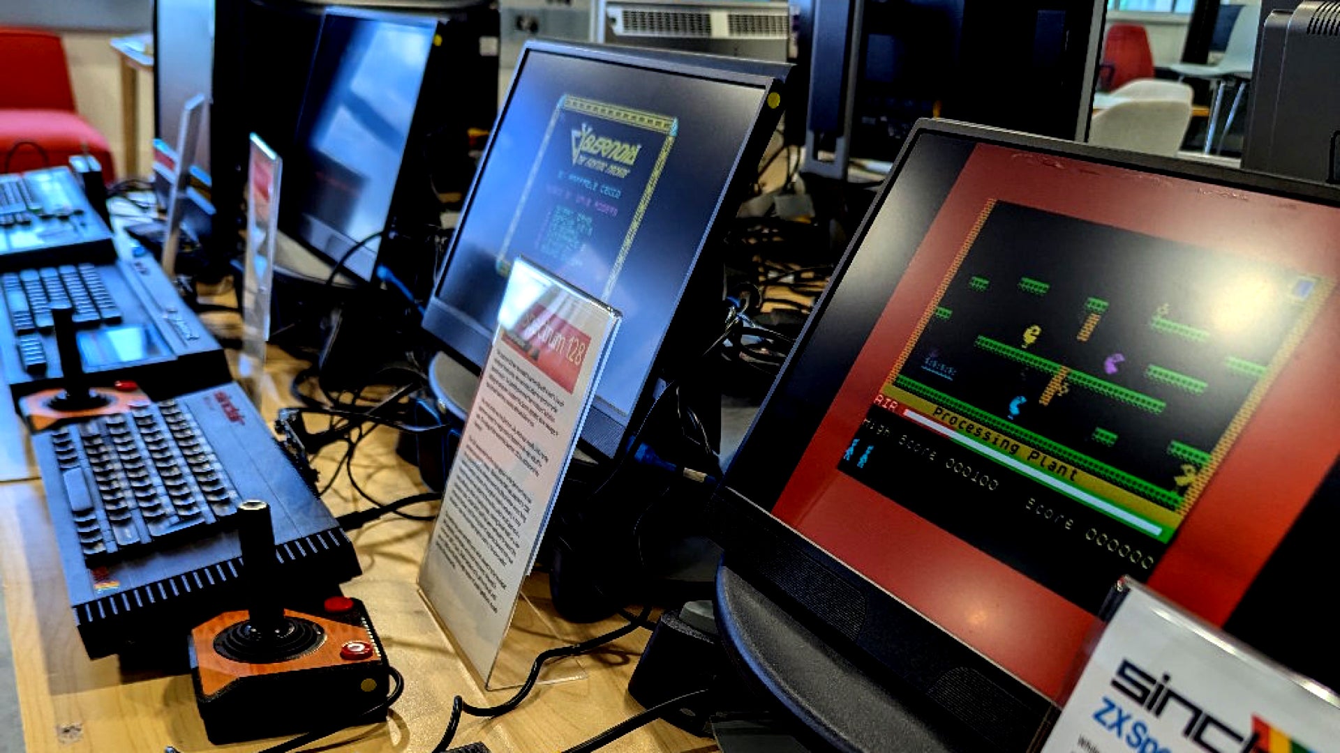 Photograph showing several generations of Spectum home computers running different games on attached monitors.