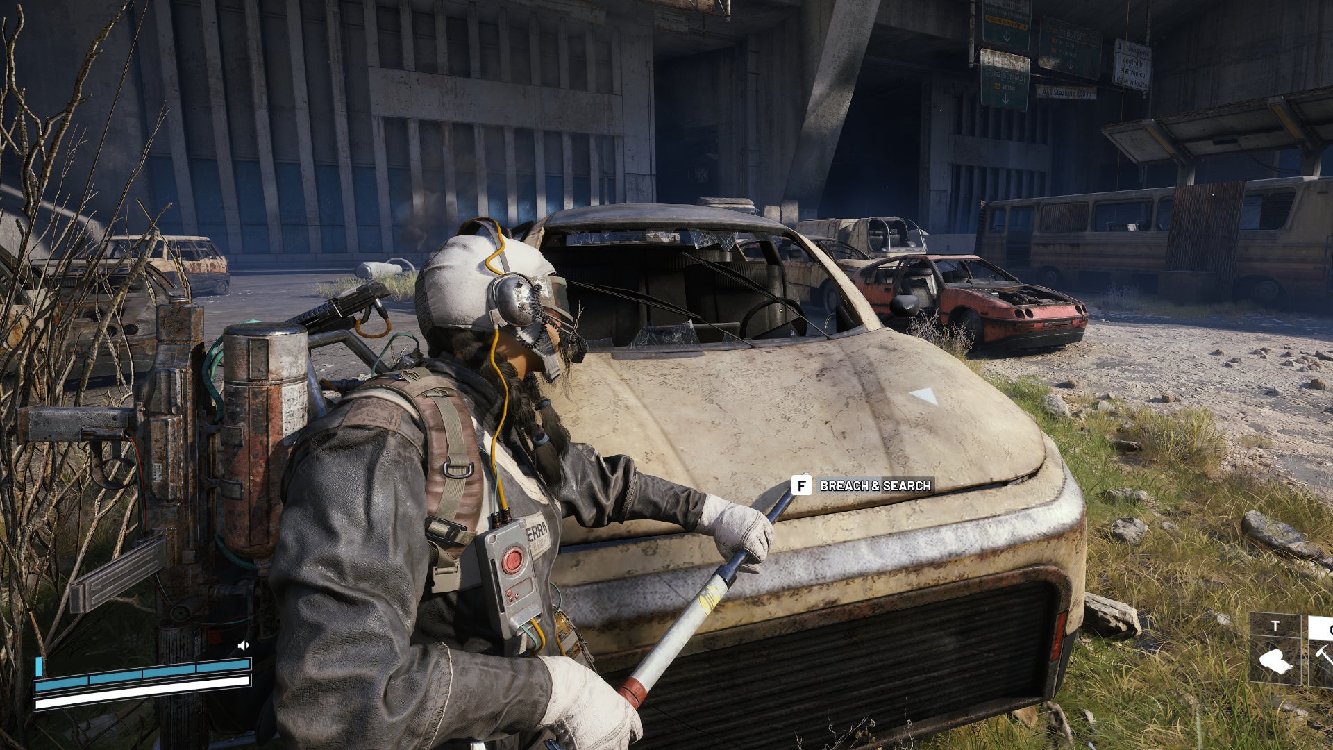 A close-up of a player in Arc Raiders using a crowbar to breach and search the hood of a broken down car in the Checkpoint area of the Blue Gate map. - 5