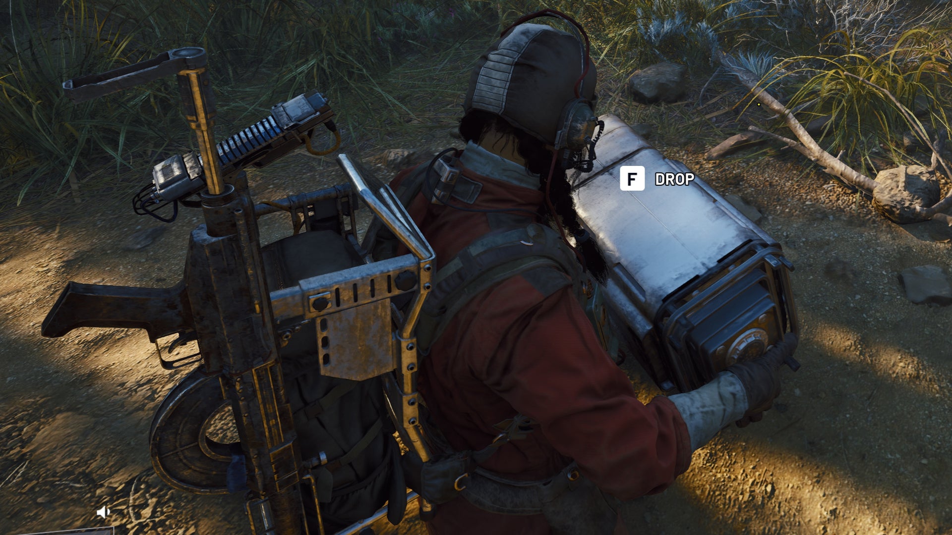 A close-up of a player character in Arc Raiders, with a backpack full of gear, carrying an ARC Field Crate with both hands outdoors. - 1