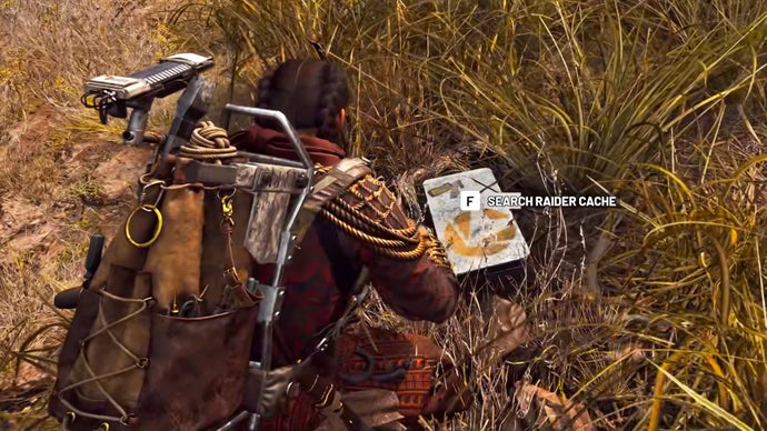 A raider in Arc Raiders kneels down in the grass and opens a grey raider cache container.