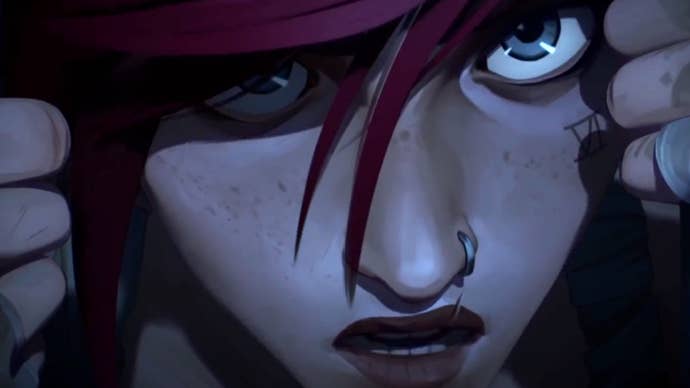 A still from Arcane: Act 2 showing a close-up of Vi pulling back her hood and revealing her face.