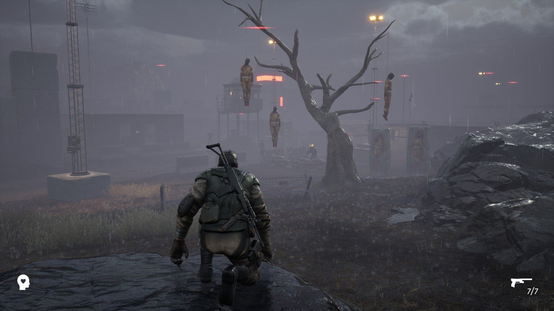 The hero crouches and looks at a tree in the misty distance, from which hangs three bodies in prison overalls. - 1