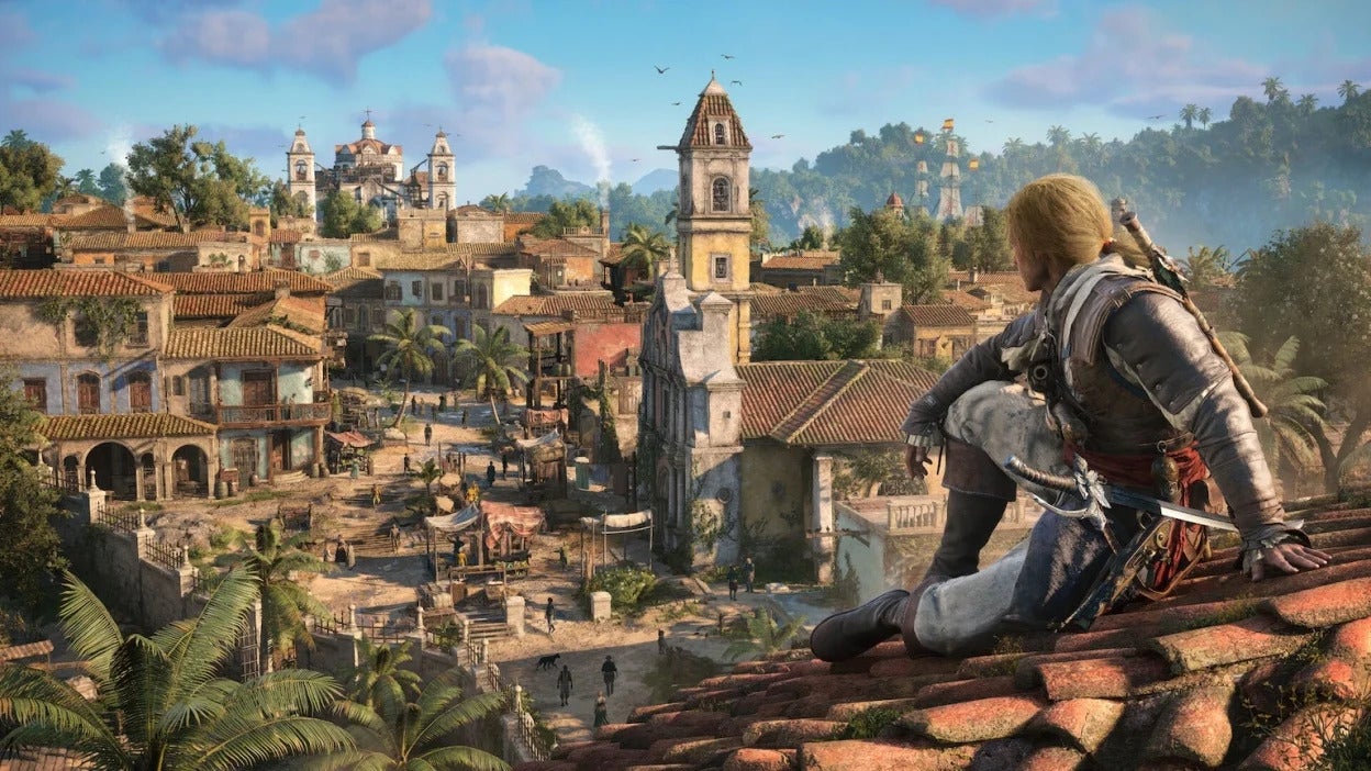 A blonde-haired individual in pirate attire sits on a terracotta tiled rooftop, gazing over a sprawling, sun-drenched colonial town with Spanish-style architecture and lush tropical foliage.
