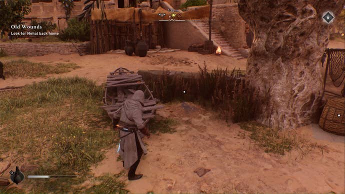 assassins creed mirage, Basim is looking down at a pile of dirt between an old boat and a big tree