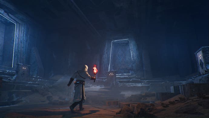 assassins creed mirage basim holding flame torch in secret underground chamber
