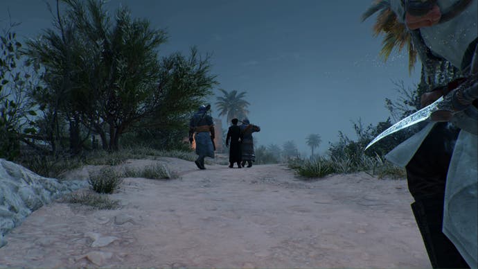 assassins creed mirage basim is crouching behind a tha'abeen and two guards on a rural road