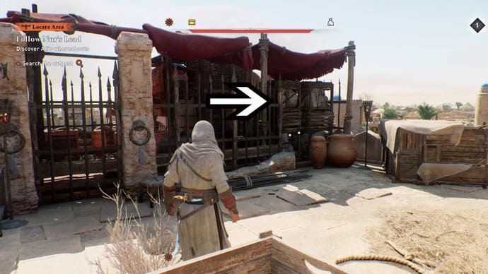 assassins creed mirage, Basim facing the khurasan gate guardhouse gear chest puzzle entrance. An arrow is pointing to a set of large crates.