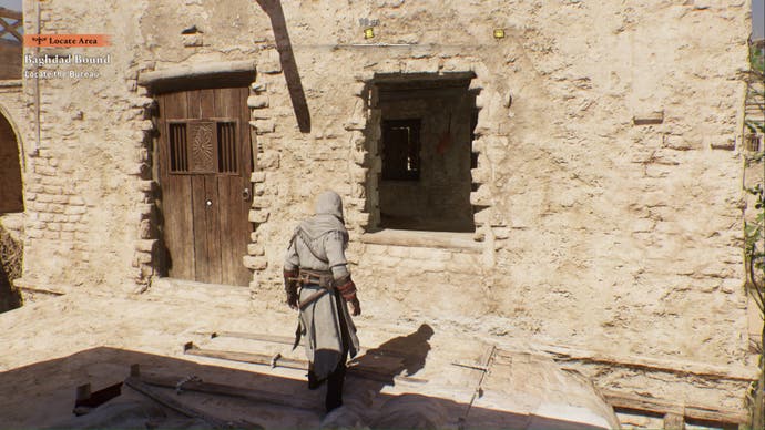 assassins creed mirage, Basim is facing a window leading inside a building with a blocked door on his left.