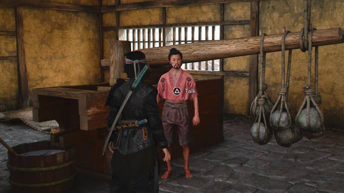 Naoe speaking to a food vendor in Assassin’s Creed Shadows.