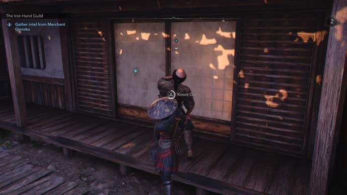 Naoe grabbing the Iron Hand Guild merchant, Ginroku, in Assassin’s Creed Shadows.