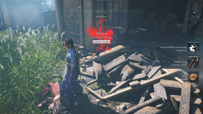 Naoe, the protagonist of Assassin’s Creed Shadows, stands outside a ruined building over the body of Mucho, a kidnapper.