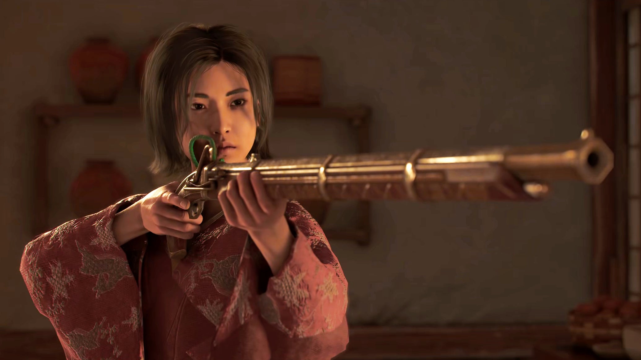 Naoe in Assassin's Creed Shadows aims a golden teppo at someone off-screen indoors. - 1