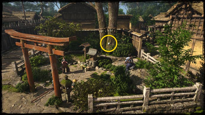 A shot of a tree in a garden in Osaka in Assassin’s Creed Shadows, with a yellow circle highlighting the location of a blue Origami Butterfly.