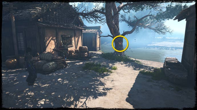 A close-up of a tree overlooking a river in Osaka in Assassin’s Creed Shadows, with a yellow circle highlighting the location of an orange Origami Butterfly.
