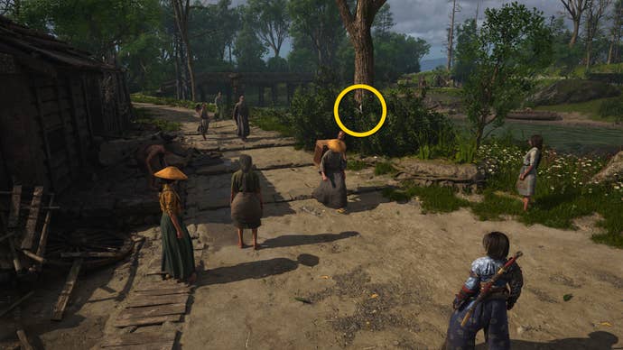 A close-up of a tree by a road in Osaka in Assassin’s Creed Shadows, with a yellow circle highlighting the location of a white Origami Butterfly.