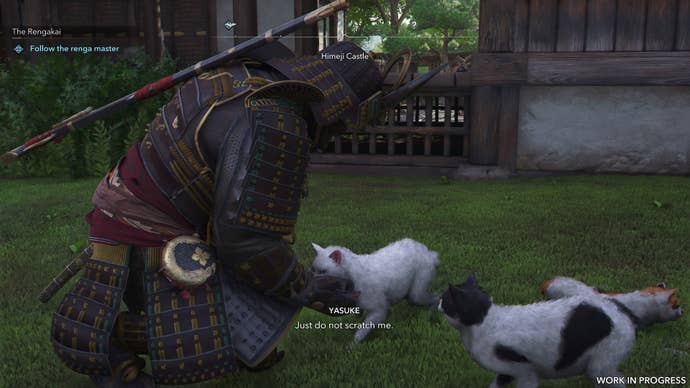 Yasuke pets a cat in Assassin’s Creed Shadows.