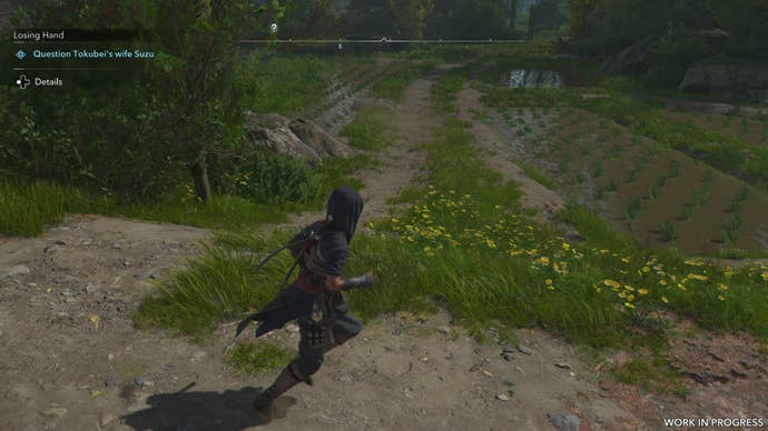 Naoe runs past a rice field in the spring time in Assassin’s Creed Shadows. The water is clearly visible in the field.