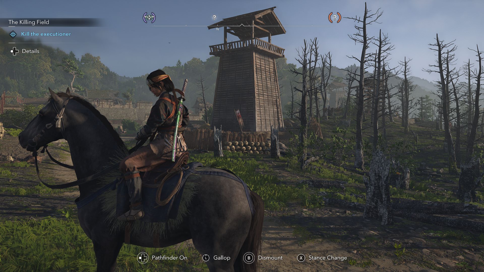 Naoe sits on horseback with a tower in the distance on a hillside. - 1