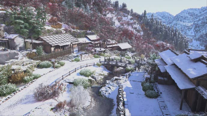 Winter snow covers several houses and country roads in Assassin’s Creed Shadows.