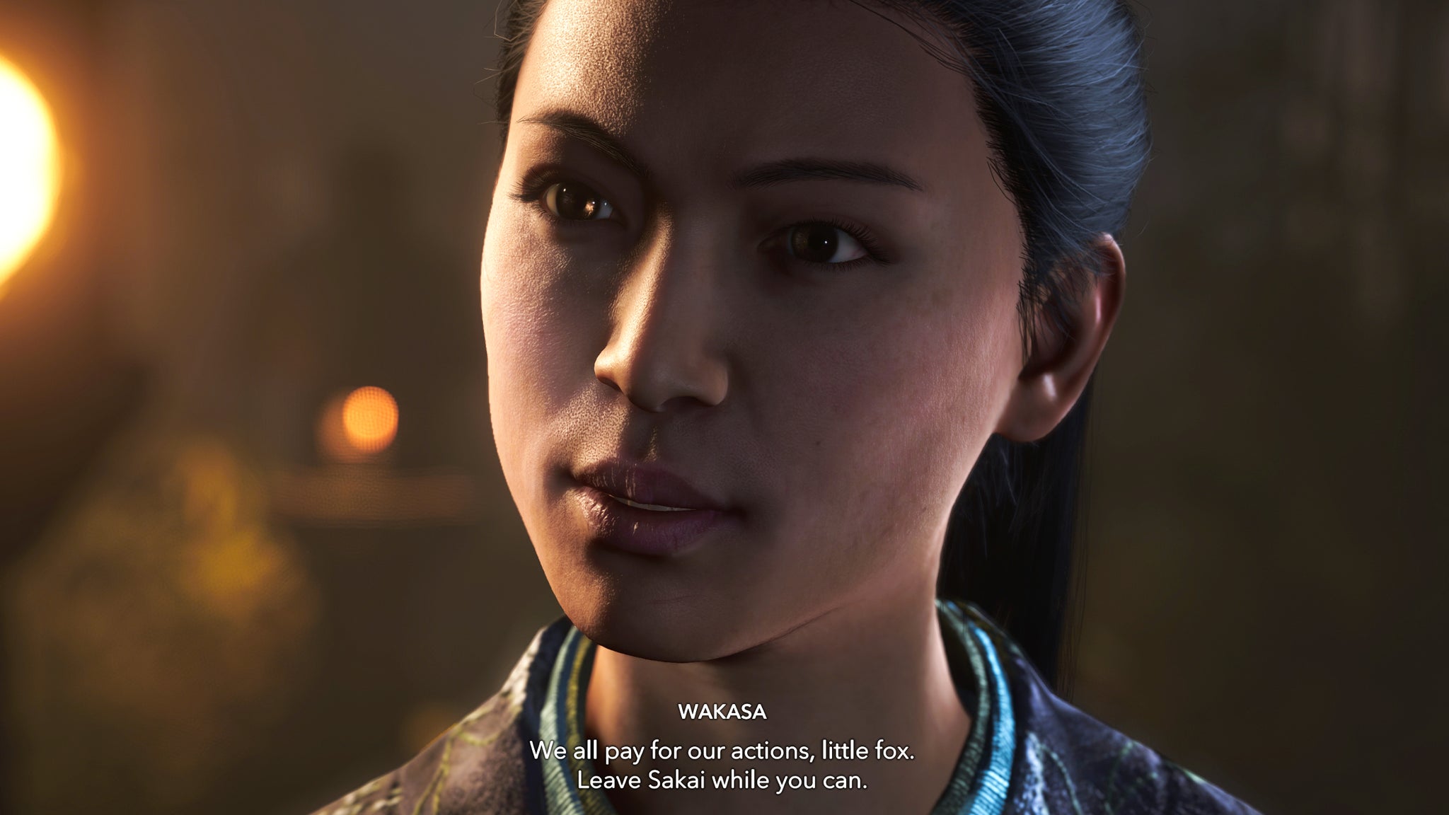 A close-up of Wakasa's face in Assassin's Creed Shadows as she threatens Naoe. - 9