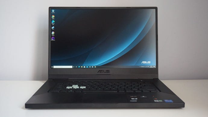 A photo of the Asus TUF Dash 15 gaming laptop on a white desk