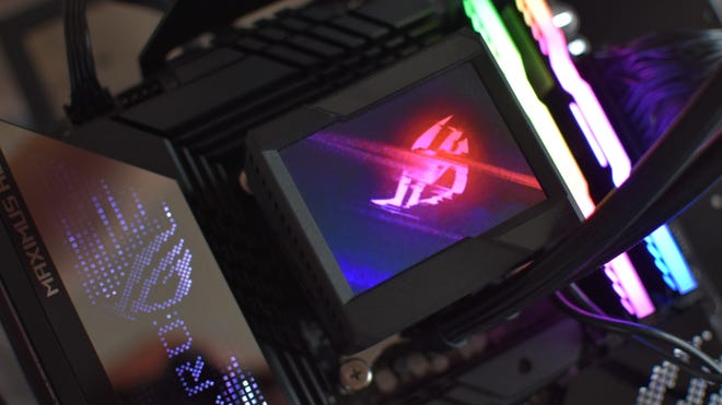 An Asus ROG Ryujin II 360 cooler pump, with its built-in display showing a ROG logo.