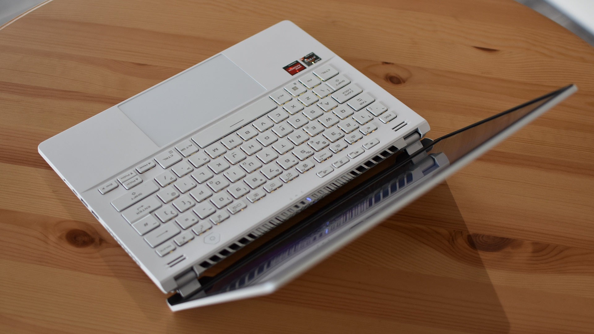 A top-down view of the Asus ROG Zephyrus G14 gaming laptop, on a table.