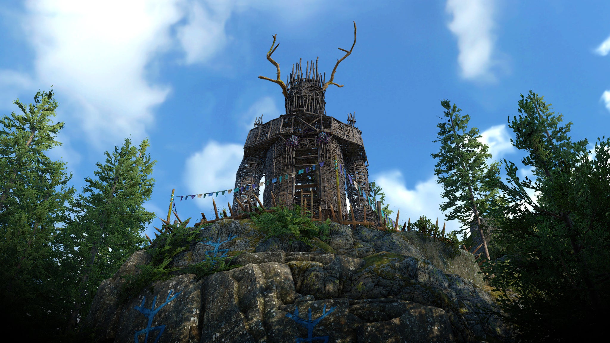 A huge wickerman effigy looming over treetops against a sunny blue sky in Atomfall. - 5