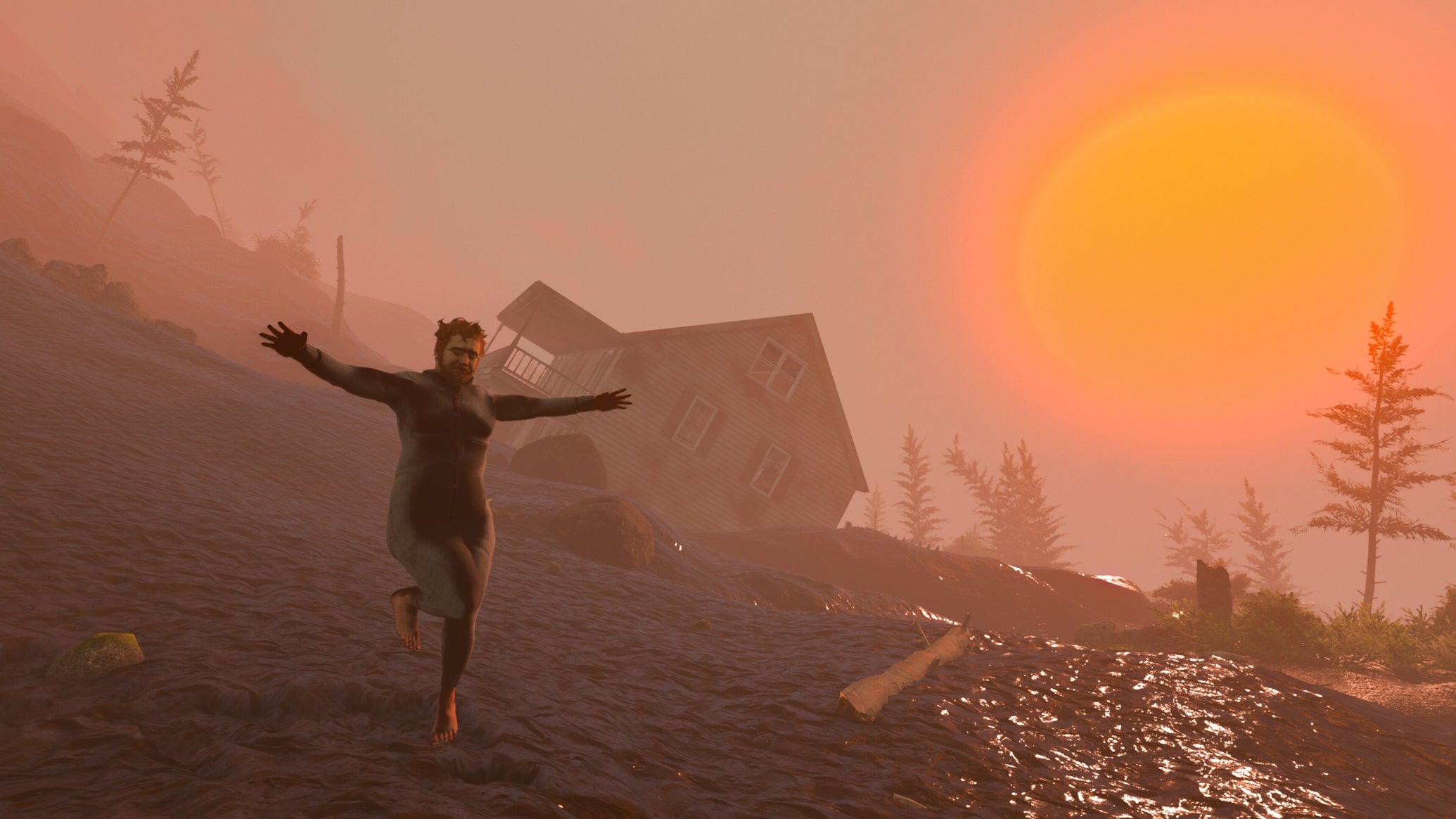 Nate lifts his arms in a t-pose as the sun sets behind him on a hill. - 1