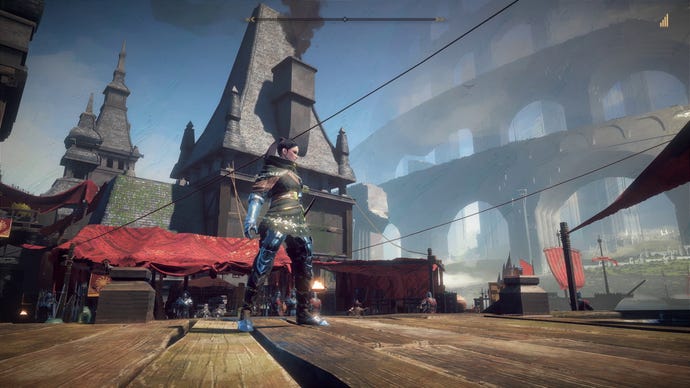 A woman stands in a medieval market town in Babylon’s Fall