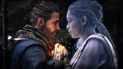 A side-on screenshot of a bearded and ponytailed man and a ghostly, braided-haired woman, pulled tight, holding hands, and looking at each other lovingly. Magic glows where their hands touch.