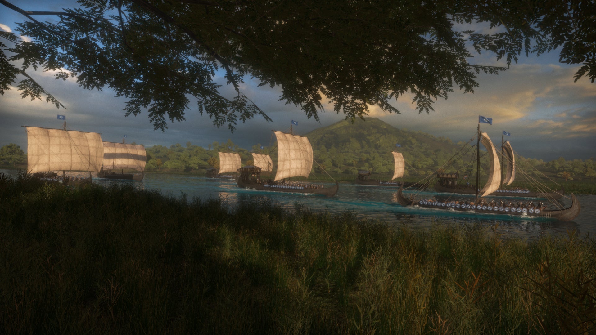 A number of Sturgian ships travelling along a river in Mount and Blade II: Bannerlord.