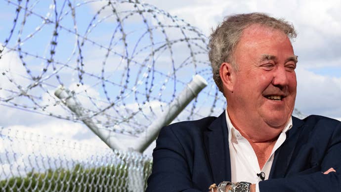 Jeremy Clarkson laughing in front of a prison fence