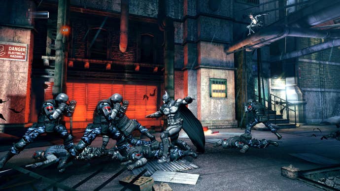 Batman fighting enemies, with Catwoman in the background, in the side scrolling game Batman: Arkham Origins Blackgate.