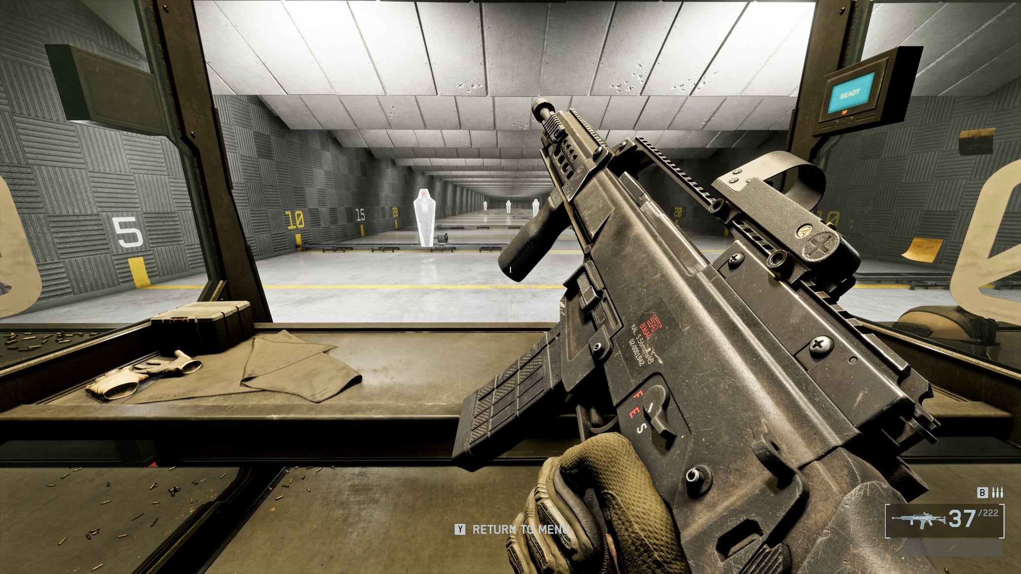 A close-up of the B36A4 Assault Rifle in Battlefield 6, with the gun tilted sideways by the player, angling towards the top left of the screen. In the background is a firing range. - 1