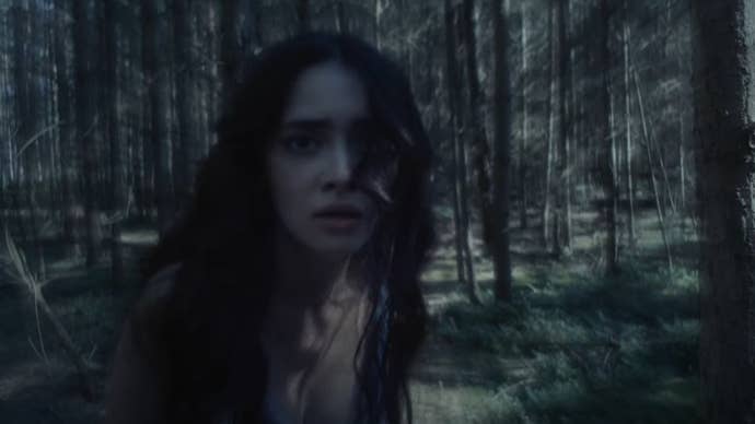 The woman in a forest from the ‘The Beast is Coming’ teaser.