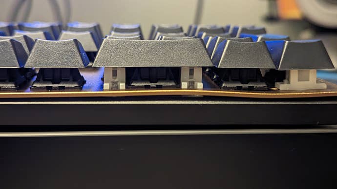 cherry kc 200 mx keyboard with a visible bend in its metal plate under the numpad’s zero key.