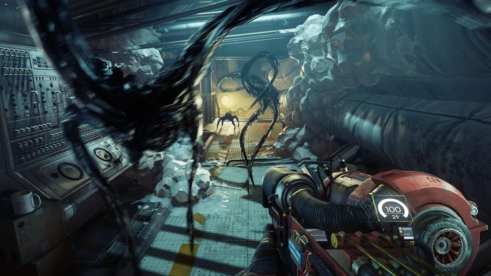 The player is attacked by spidery black creatures in a space station corridor.
