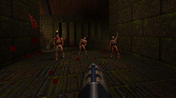 Three zombies approach the player in Quake