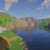 A screenshot of a river in Minecraft, with some trees on either side of the bank and a hill in the distance, taken using Beyond Belief shaders.