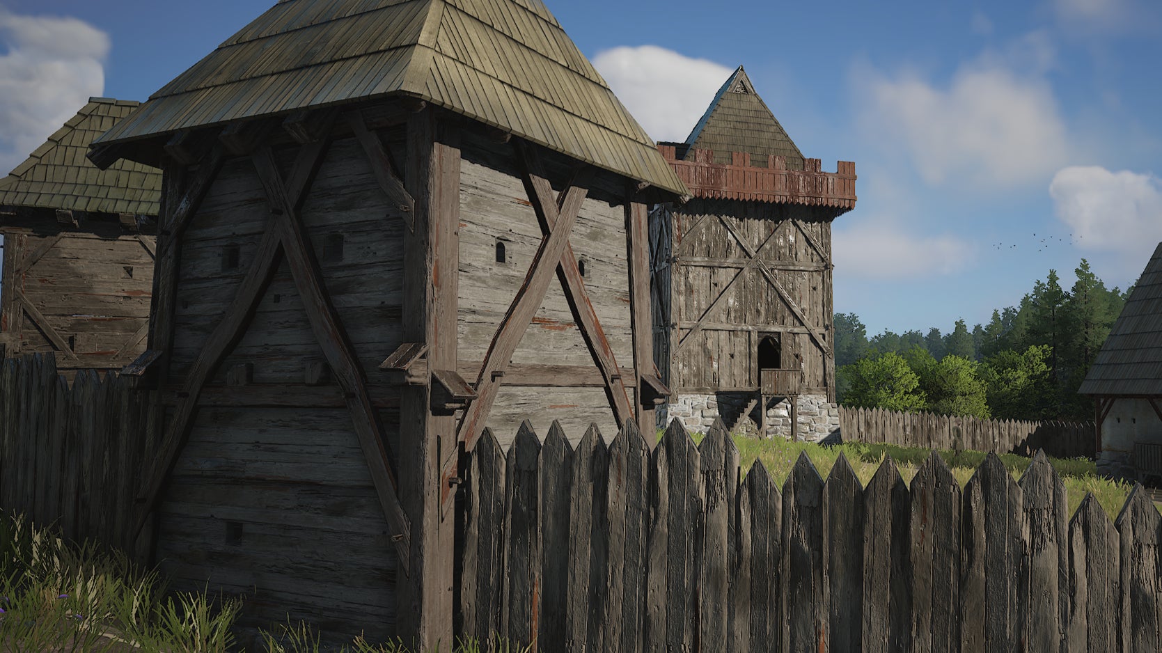 A view of a wooden castle wall and tower from Manor Lords - 1