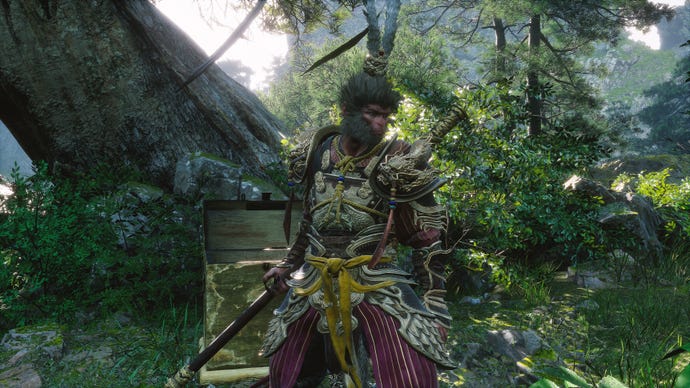 The player in Black Myth: Wukong stands in front of a chest in the Verdant Path, wearing the secret Fortune’s Favor armour set.