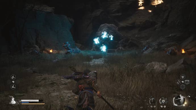 The player in Black Myth: Wukong approaches the Mother Of Stones boss in a cave.