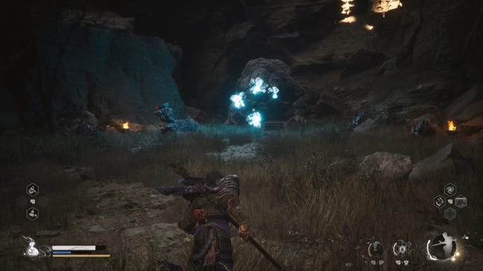 The player in Black Myth: Wukong approaches the Mother Of Stones boss in a cave.