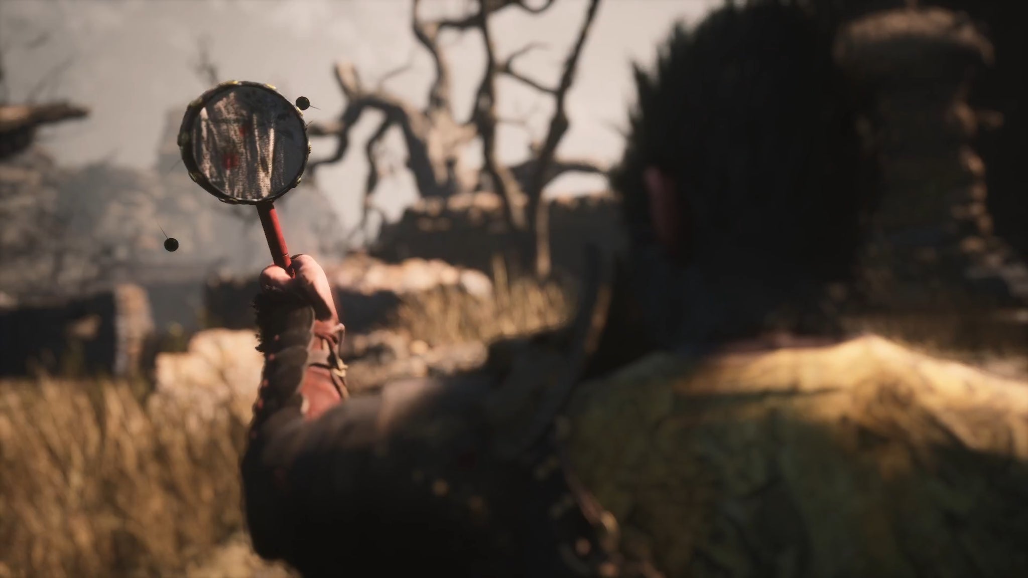 The player in Black Myth: Wukong shakes the Old Rattle-Drum in a cutscene. - 16