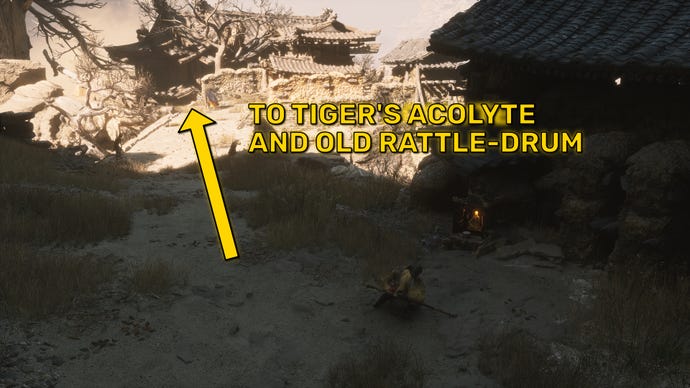 The player in Black Myth: Wukong skids to a halt next to a Keeper’s Shrine in Chapter 2. A yellow arrow points across a nearby bridge towards the location of the Tiger’s Acolyte boss.