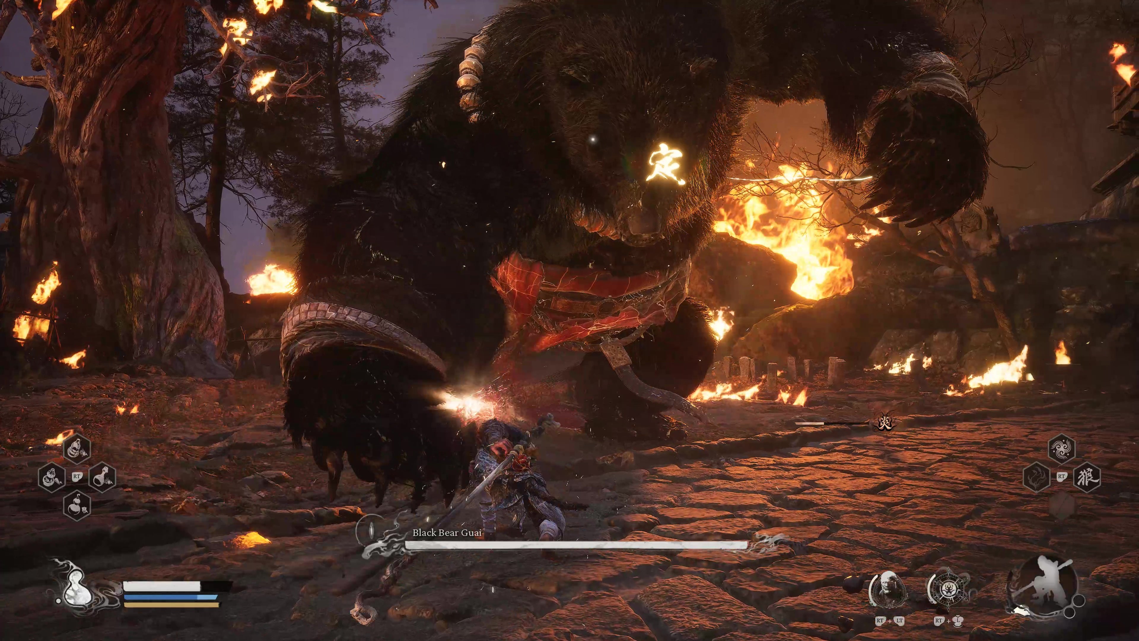 A monkey warrior fights a large bear in a burning forest in Black Myth Wukong.