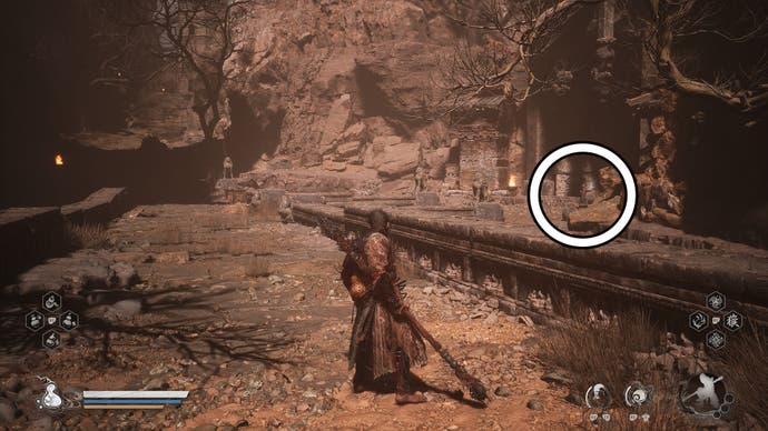 A monkey warrior approaches a gate in a desert in Black Myth Wukong